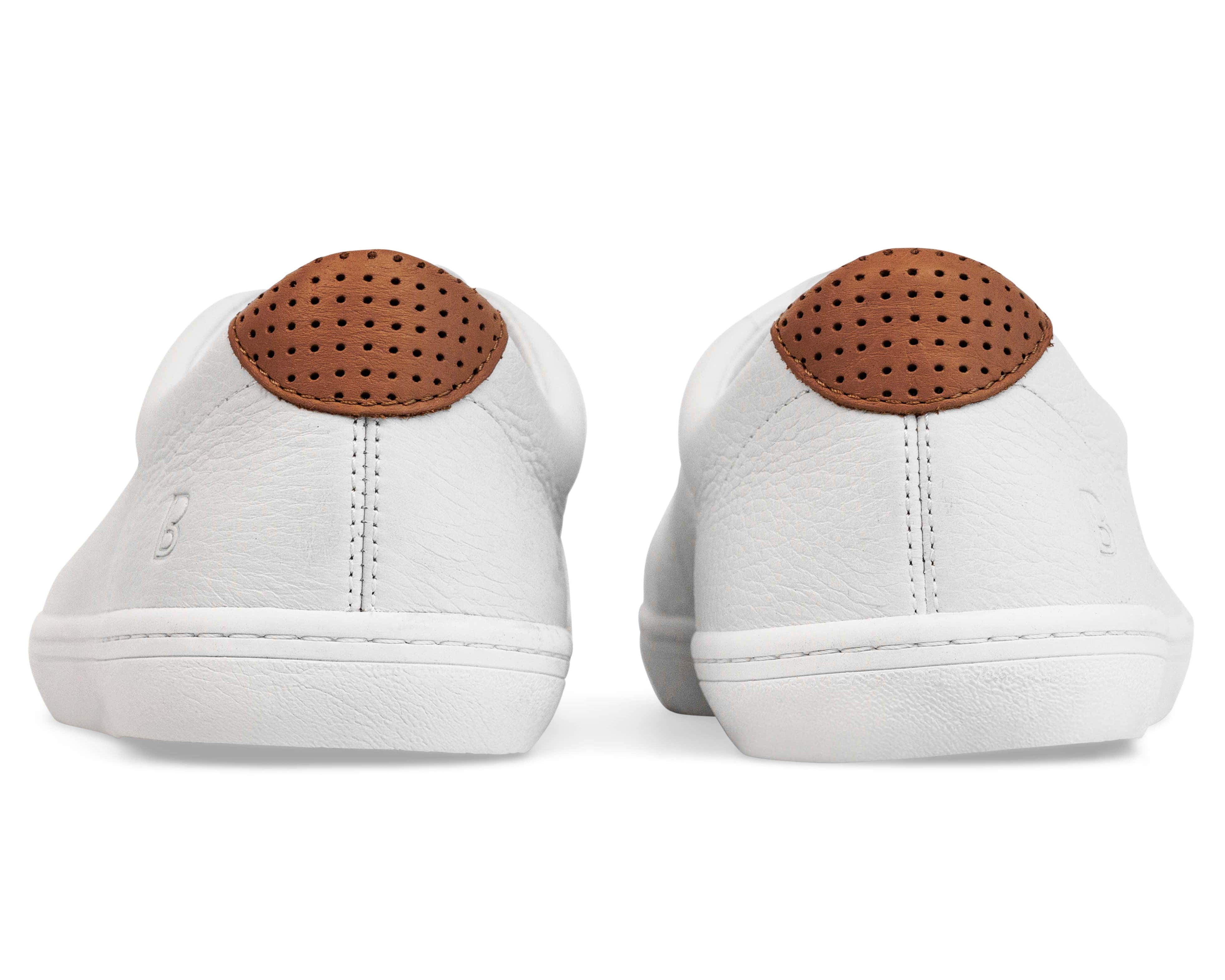 Back view of white sneakers with brown perforated heel detail.