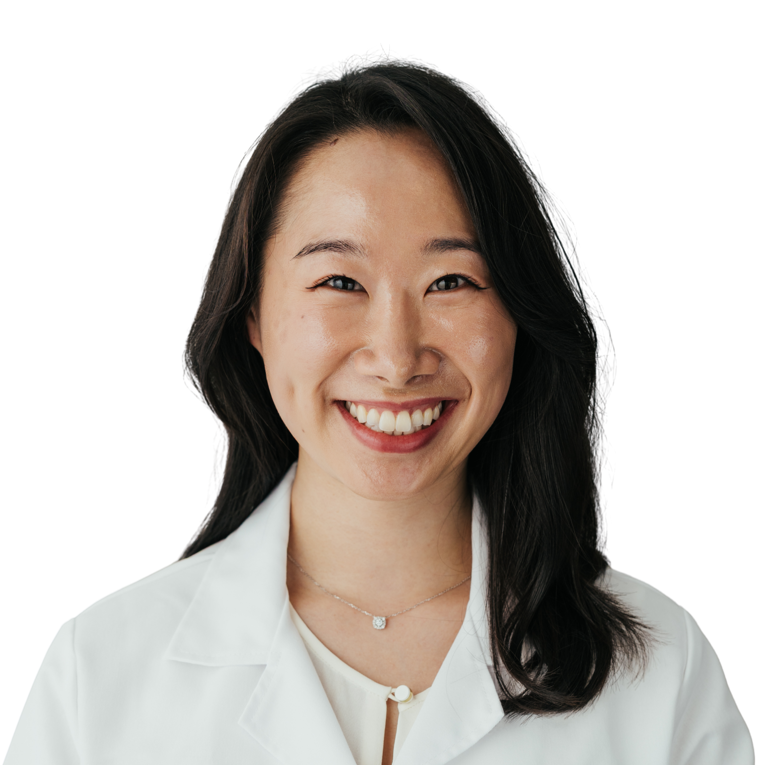 Person smiling, wearing a white lab coat, with a plain background.