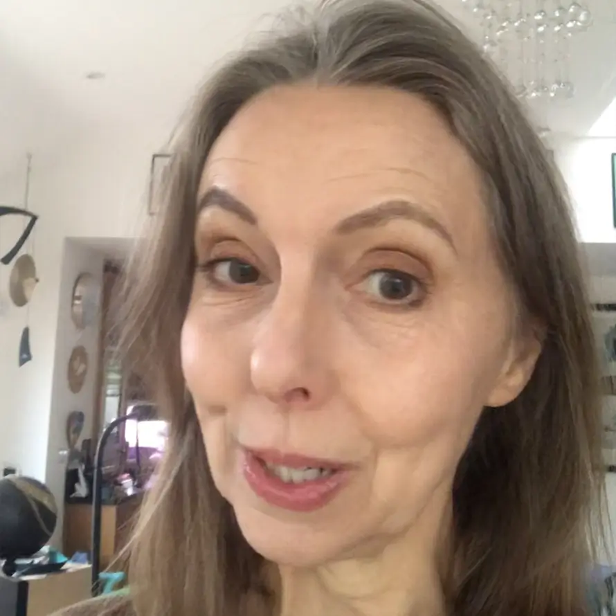 I don't know who this is, but it's a close-up of a person in a room with decor.